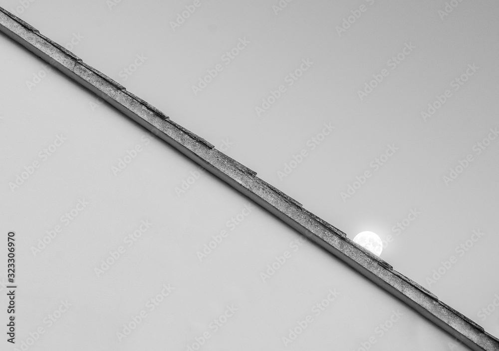 the moon over a roof the moon over a roof