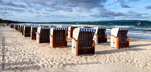 Sandy beach and traditional wooden beach chairs on Rügen island, Northern Germany, on the coast of Baltic SeaWooden beach chairs on Rügen island © EKH-Pictures