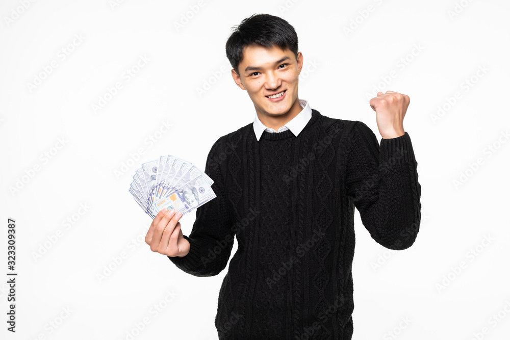 Portrait of excited chinese man with win gesture showing many banknotes isolated on white background Portrait of excited chinese man with win gesture showing many banknotes isolated on white background