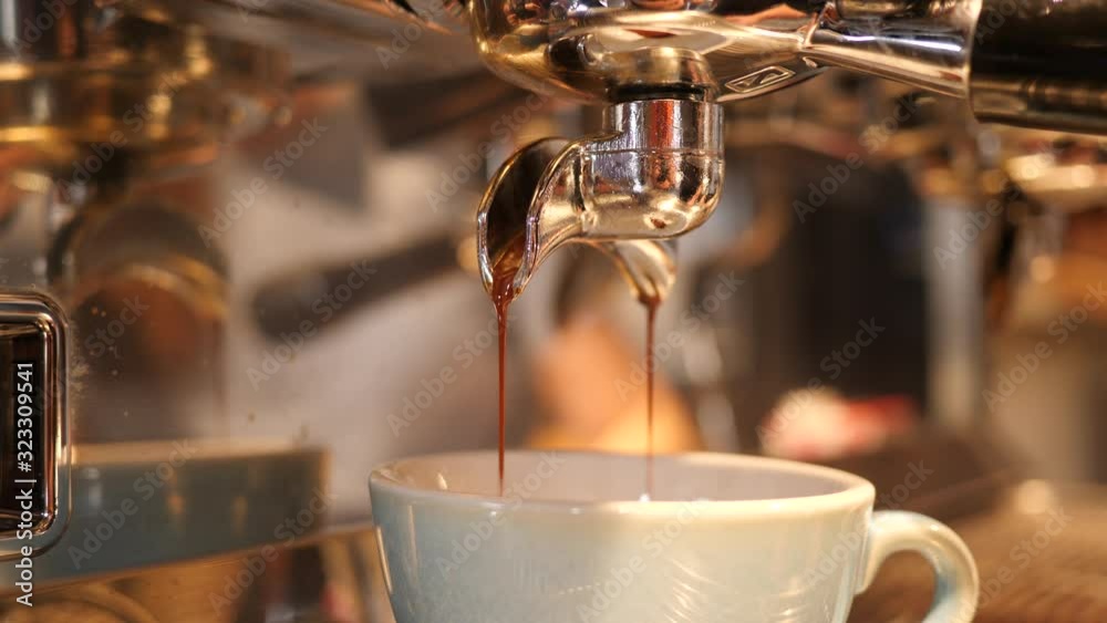 Coffee machine making a cappuccino and espresso hot drink in cafe bar at the morning