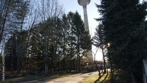 Professional cinematic touristic view of national TV tower of Tallinn, Estonia, 9.2.2020 this old 80's tower hidden behind trees is one of most famous spots for tourism in this baltic city. photo