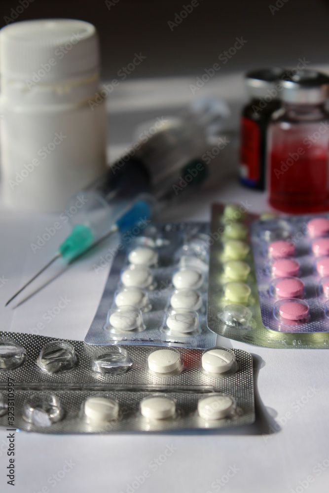 Pills and syringe, thermometer and drugs. Pills and syringe, thermometer and drugs.