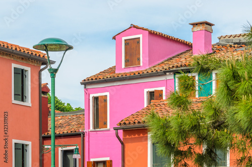 Colorful apartment building with nice waterfront view in Burano, Venice, Italy.