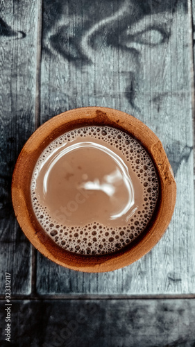 A kulhar or kulhad cup (traditional handle-less clay cup) from North India filled with hot Indian tea