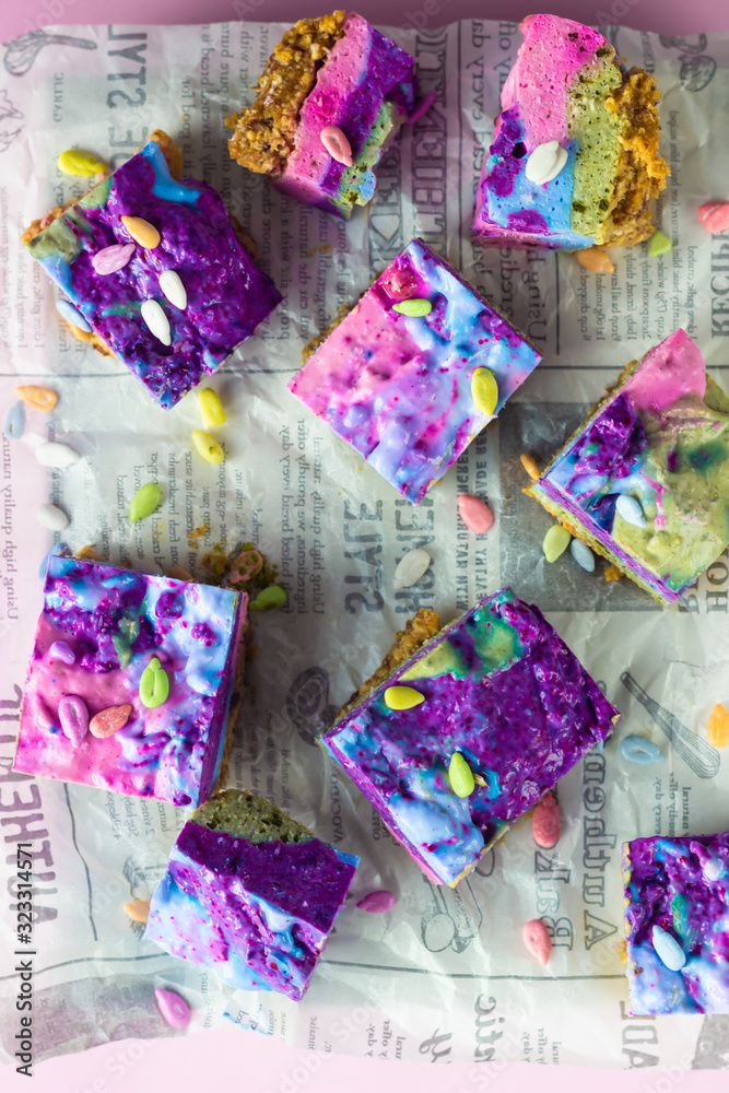 Raw vegan colorful cheesecake (cashew cake) on a piece of paper. Dessert made with Filipino superfood yam or ube. Healthy lifestyle and raw vegan dessert concept. 