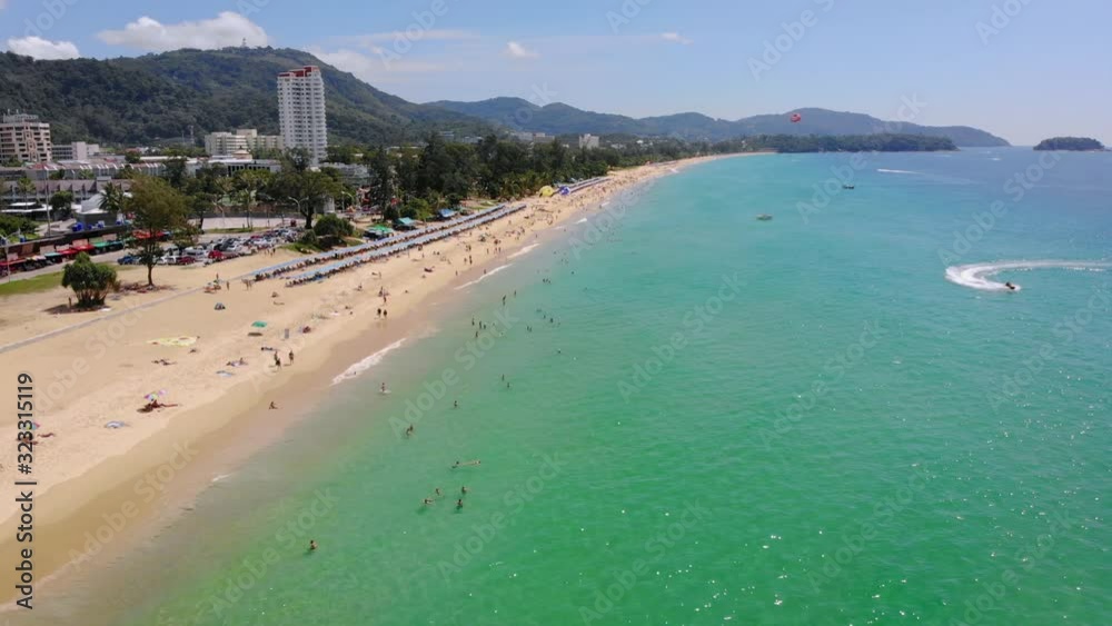 AERIAL: Coastline from the city of Phuket. Crystal clear water. People swimming. Sunny day. Thailand AERIAL: Coastline from the city of Phuket. Crystal clear water. People swimming. Sunny day. Thailand