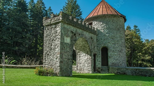 Hiker couple walking into an old castle architecture entrance and surroundings in Ilirska Bistrica, Slovenia. photo