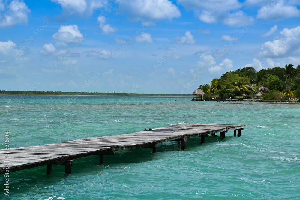 a wood way platform in a turquoise water and nature paradise background