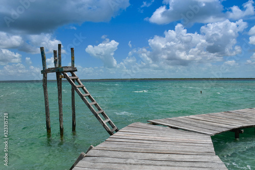 a wood way platform in a turquoise water and nature paradise background © Cruzcaba
