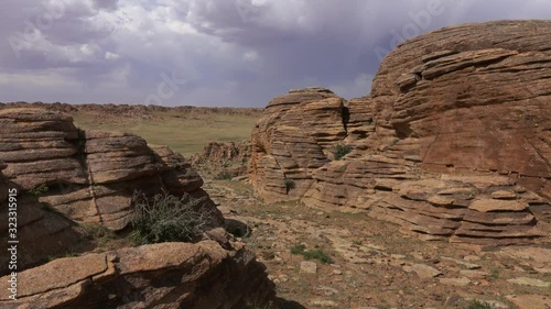 Rock formations and stacked stones on granite hilltops, Baga Gazriin Chuluu, Gobi desert, Mongolia, panorama 4k photo