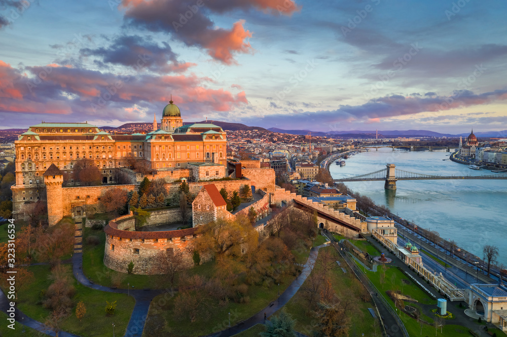 Budapest, Hungary - Golden sunrise at Buda Castle Royal Palace with Szechenyi Chain Bridge, Parliament and colorful clouds