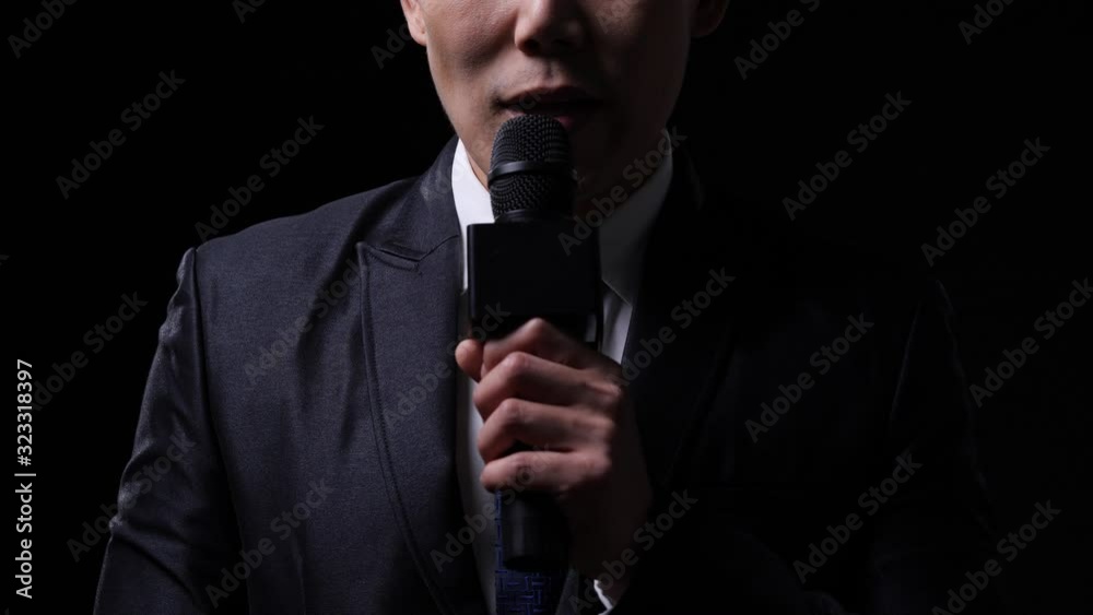 Male newscaster is reporting unusual circumstances and reporting economic news with isolate black background. Male newscaster is reporting unusual circumstances and reporting economic news with isolate black background.