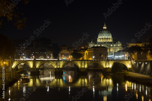 Night scene of Rome, Tevere river with basilica in background