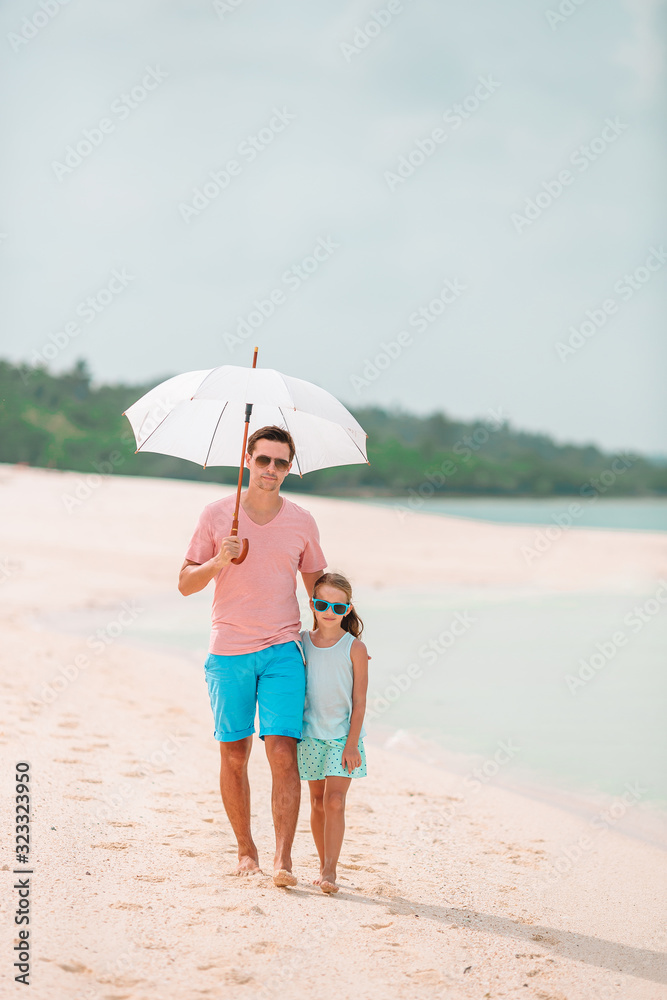 Beautiful father and daughter on the beach