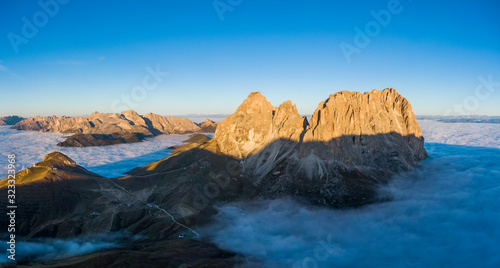 Aerial panorama of cloud sea at Sella mountain pass between the provinces of Trentino and South Tyrol, Dolomites