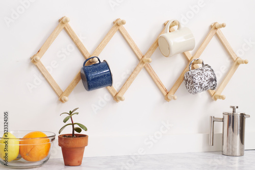 mugs hanging on rack in kitchen