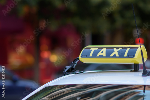 Taxi sign on top of a greek cab, intentional selective focus. copyspace for your individual text