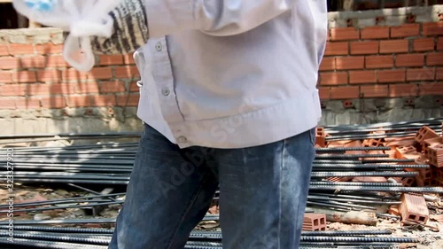 Blue collar worker taking a break at noon. Close up of women eating bread and reading a letter on sidework in harsh environment