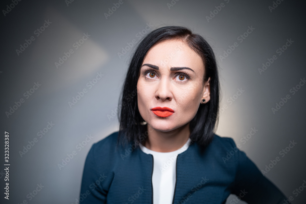 studio shot of angry young brunette woman studio shot of angry young brunette woman