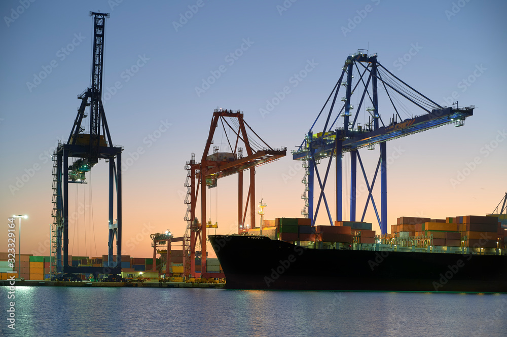 Maritime cranes in the port at night