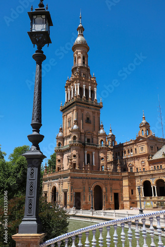view of the North Tower at the end of the neo-Moorish style building located in the beautiful Plaza de Espana in the city of Seville in Andalusia, Spain © kovalenkovpetr