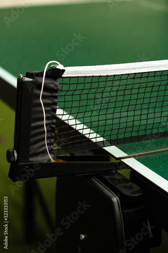 Table Tennis or ping pong rackets and balls on table. Sport concept.Texture of green wooden table,equipment for table tennis sport © MONIUK ANDRII