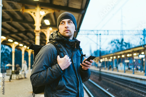 Sopot Railway station. traveler waiting for transportation. Travel concept. Man at the train station. Portrait Caucasian Male In Railway Train Station. Handsome commuter while waiting for his train