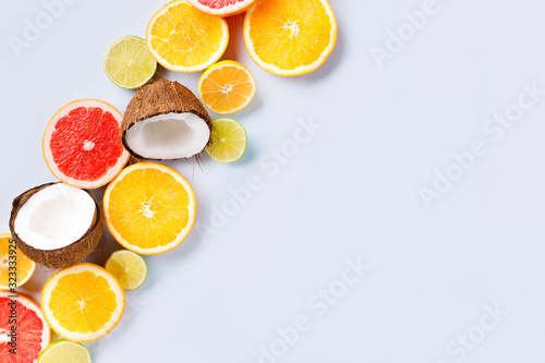 Summer holidays  resort vacation  exotic fruits background. Summertime vibes. Composition with citrus slices on white surface  copy space