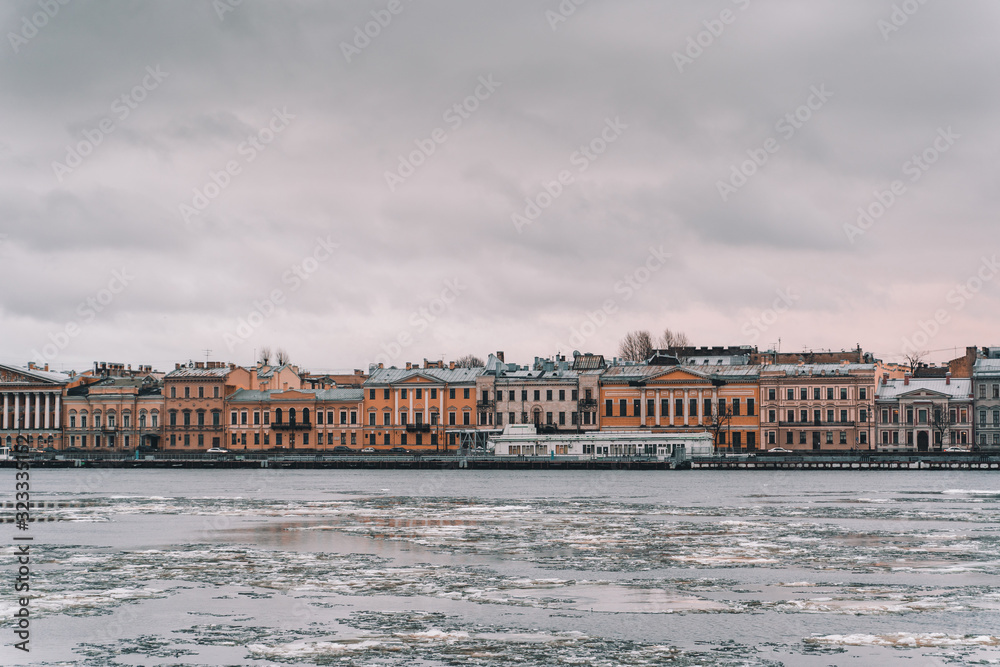 Saint Petersburg. the Neva river in the ice. view of the embankment in winter. old houses in the distance