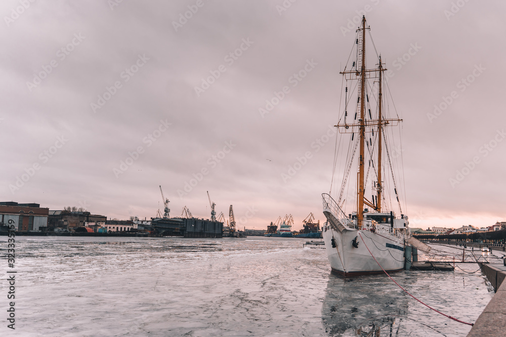 sailboat on the embankment of St. Petersburg in winter. ice on the river