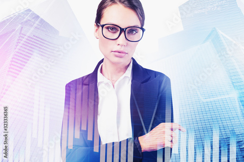 Confident businesswoman in city, financial graph photo