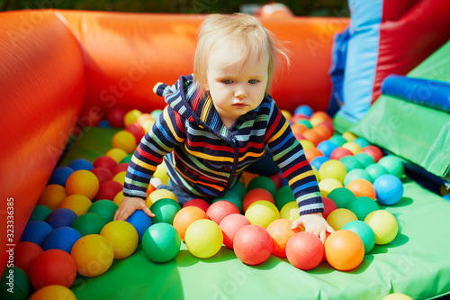 Little girl playing in ball pool