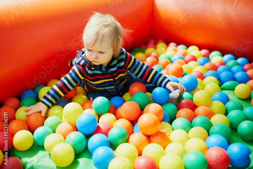 Little girl playing in ball pool