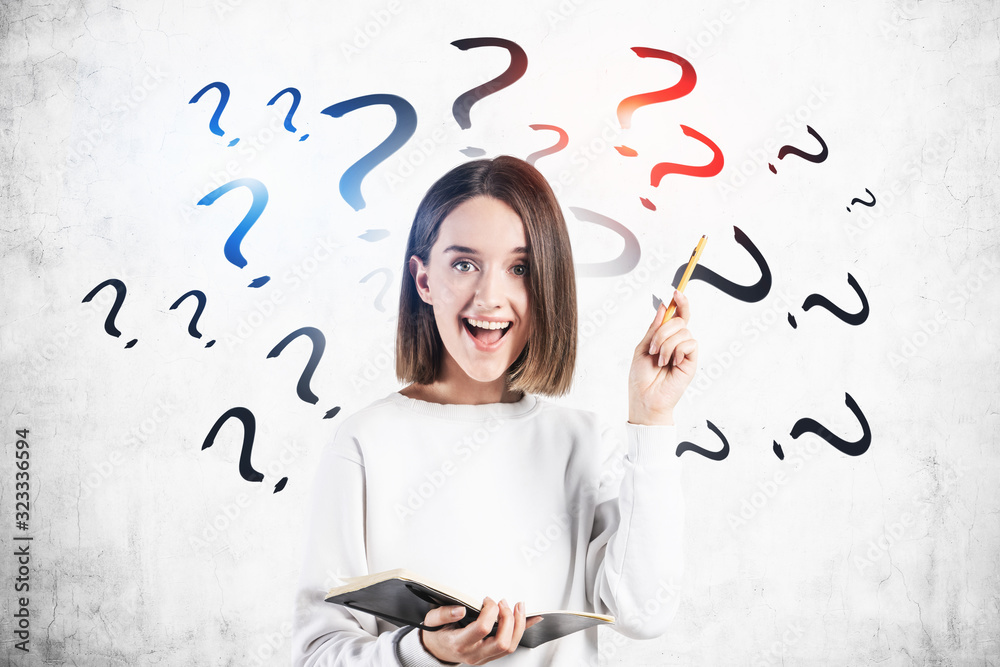 Fototapeta premium Happy teen girl with notebook, question marks