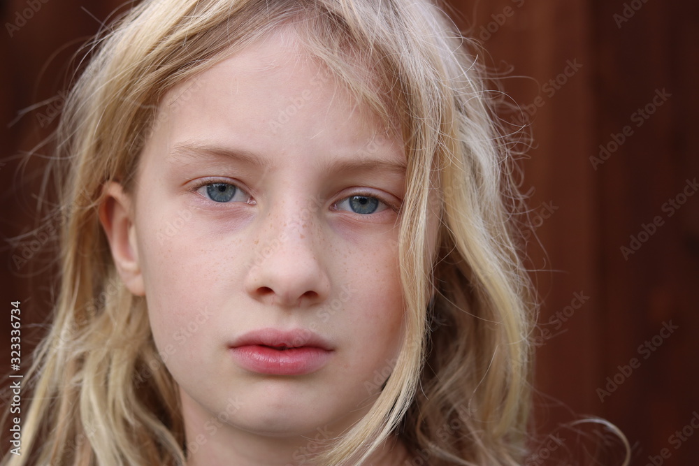 Portrait of a young teenage girl with a serious stare Portrait of a young teenage girl with a serious stare