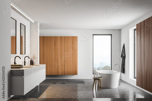 White and wooden bathroom interior with cabinet