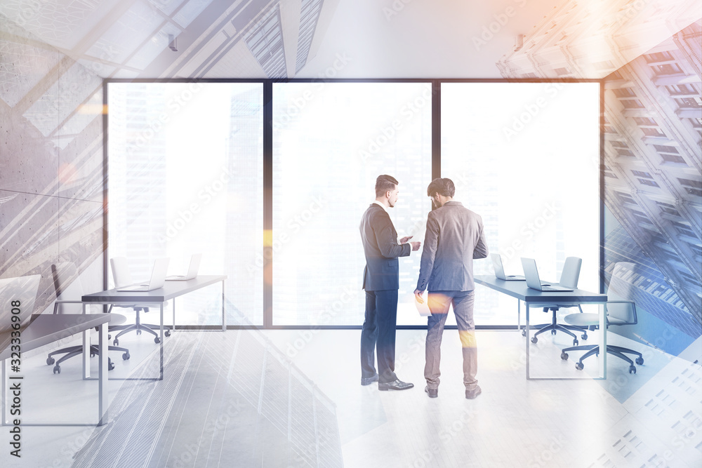 Obraz premium Two businessmen in spacious open space office