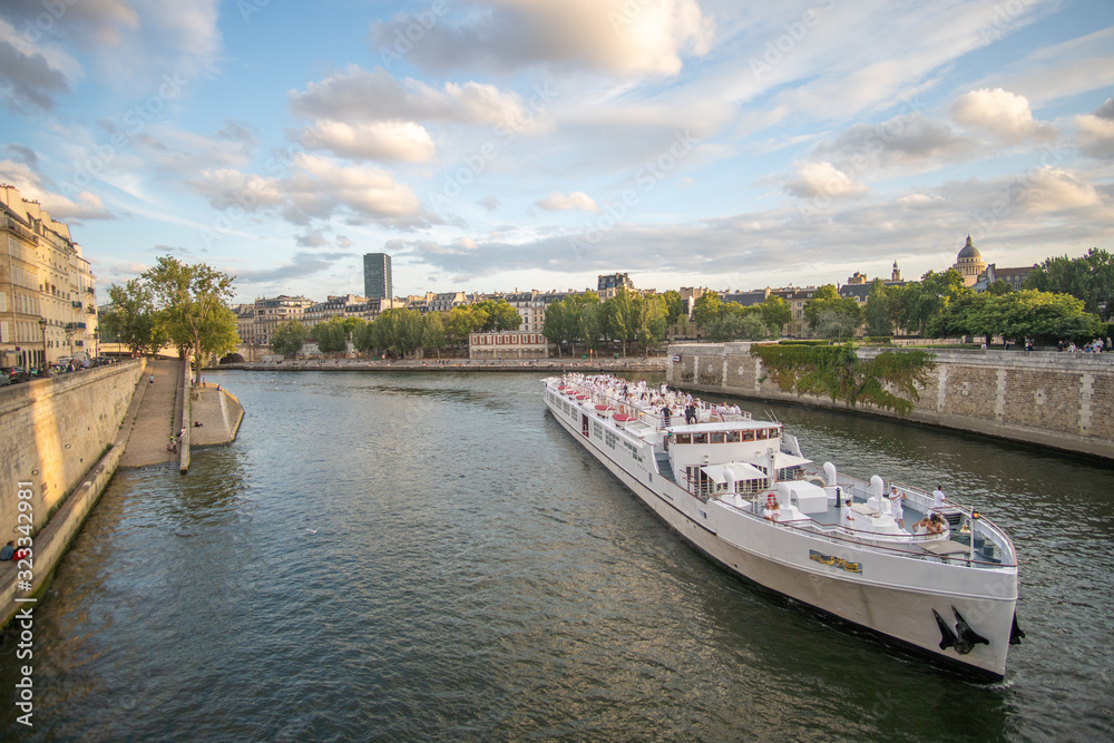Large Boat driving on seine in the evening sun in paris