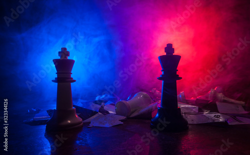Chess figures on a dark background with smoke and fog. Selective focus