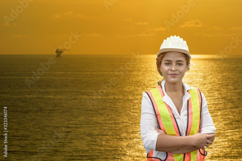 mixed race woman engineer staff worker and offshore rig background concept.