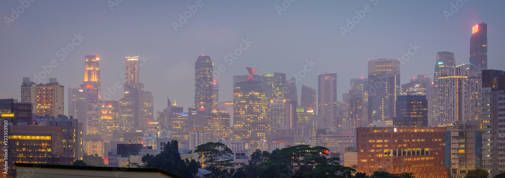 Blurry city scape of public housing in central Singapore, light bokeh during blue hour