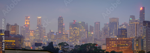 Blurry city scape of public housing in central Singapore, light bokeh during blue hour © Huntergol