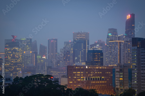 Blurry city scape of public housing in central Singapore, light bokeh during blue hour