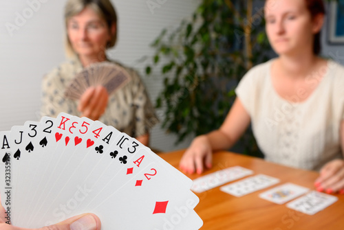 Family foursome playing Contract Bridge at home