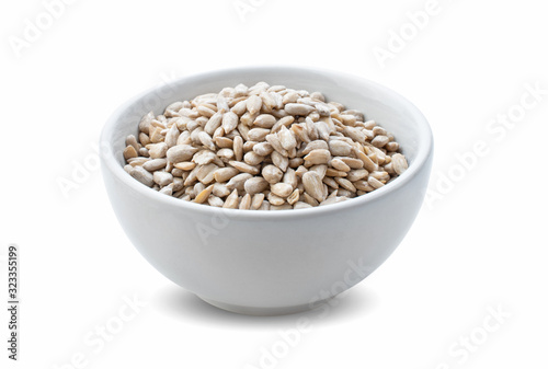 sunflower seeds in bowl isolated on white background.