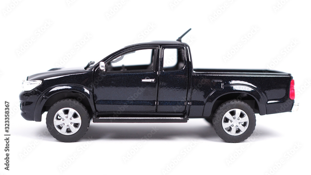 Black pickup truck mini car toy isolated on white background with shadow on ground