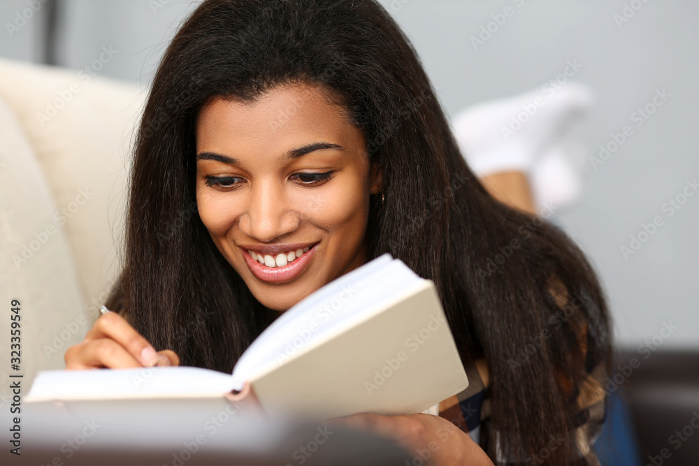 Smiling black woman write story in notebook preparing for college Smiling black woman write story in notebook preparing for college