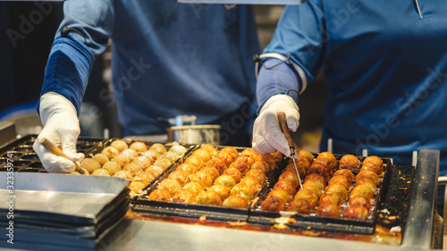 Photography Asian man cooking takoyaki ball on hot pan famous food japan street food