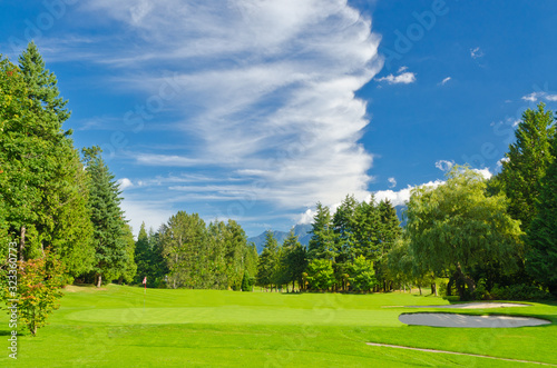 Golf place with gorgeous green and fantastic mountain and blue sky view