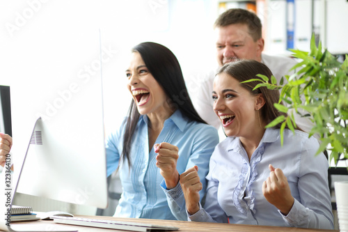 Small team employees emotionally watching events. Fans at work. People at work actively root for their team. Burst of emotions from glee to disappointment. Experience violent feelings.